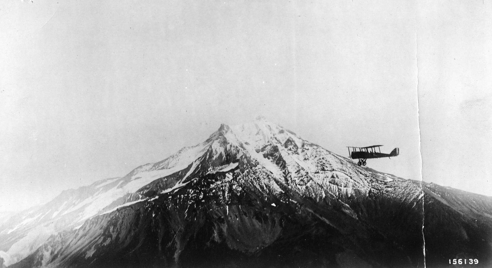Fire patrol airplane circling Mt. Jefferson in the Cascade Range, Willamette National Forest